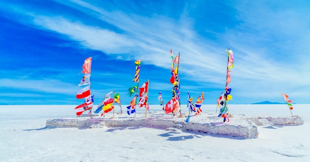 Flags of all participating countries at the Dakar monument on the Salar de Uyuni salt flats in Bolivia. Travel Tuesday
