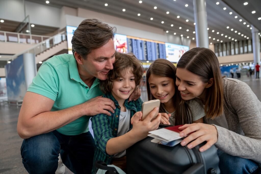 family airport phone checking flight prices best day to book family flights