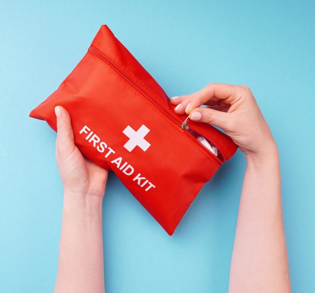 Close-up of a woman's hands holding a fully-equipped first aid kit, ready for providing immediate medical assistance in case of emergencies. Concept of preparedness, healthcare, and safety. summer vacation