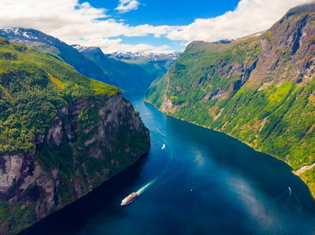 Fjord Geirangerfjord with ferry boat, view from Ornesvingen viewing point, Norway. Travel destination