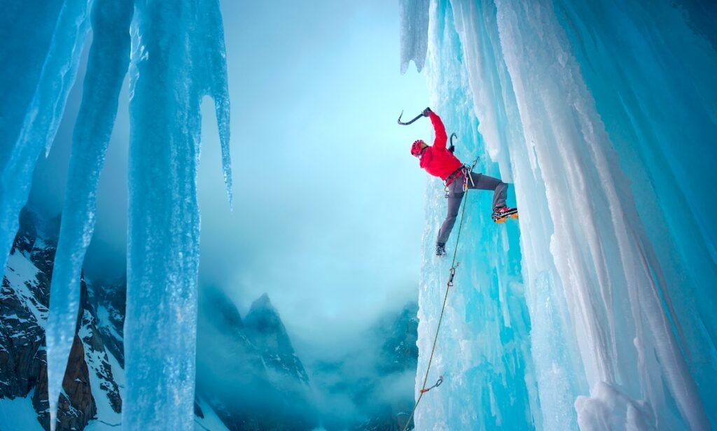 Climber ascending on a steep ice wall