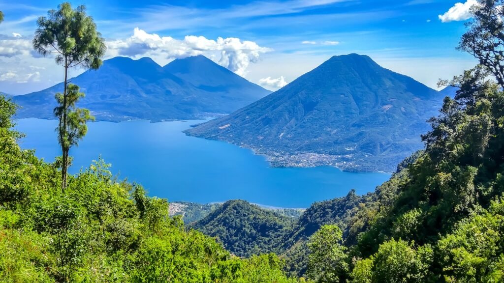 San Marcos La Laguna area, Guatemala View of surrounding volcanoes with tranquil Lake Atitlán in foreground.