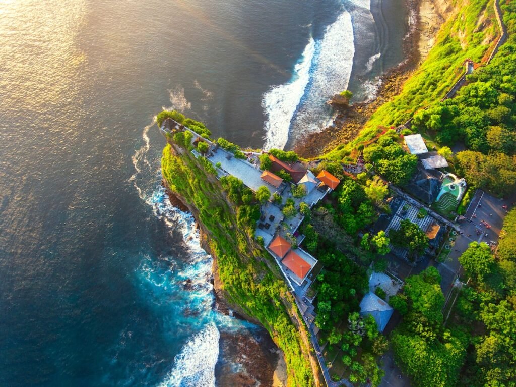 Uluwatu Temple aerial view at sunset by drone