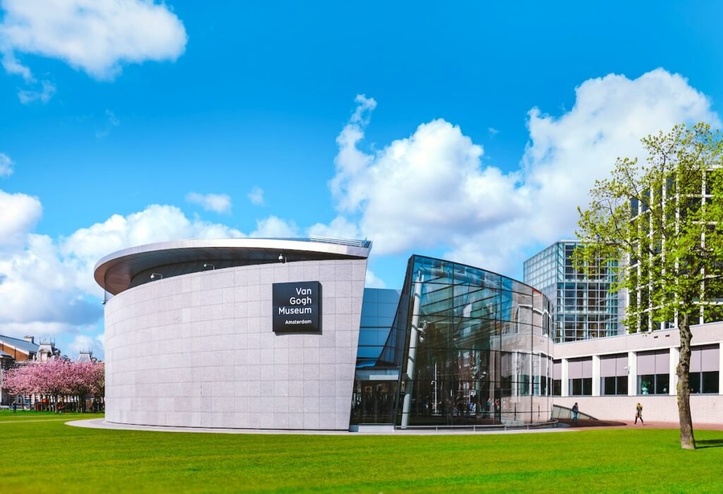 Amsterdam, Netherlands - People walking near new part of Van Gogh Museum during the spring time in Museumplein, Amsterdam. The largest collection of Van Gogh's paintings and drawings in the world. The Ultimate European Vacation: Where to Travel This Year