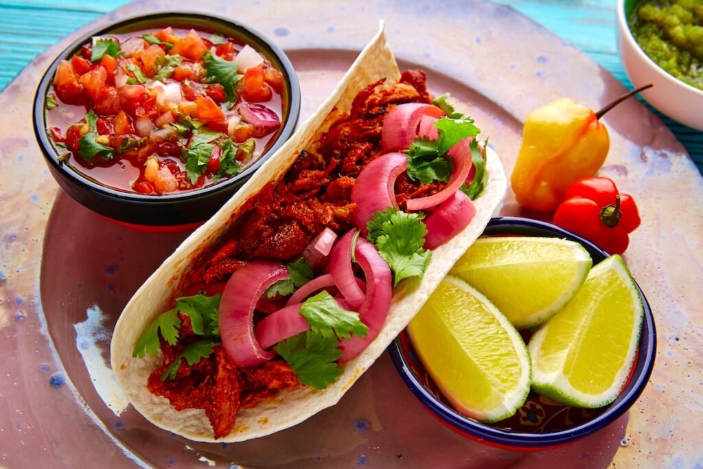 Cochinita Pibil Mexican food with pico de gallo lemon and chili Top 10 Cheap Places To Travel Now: Explore The World On A Budget #Part 1