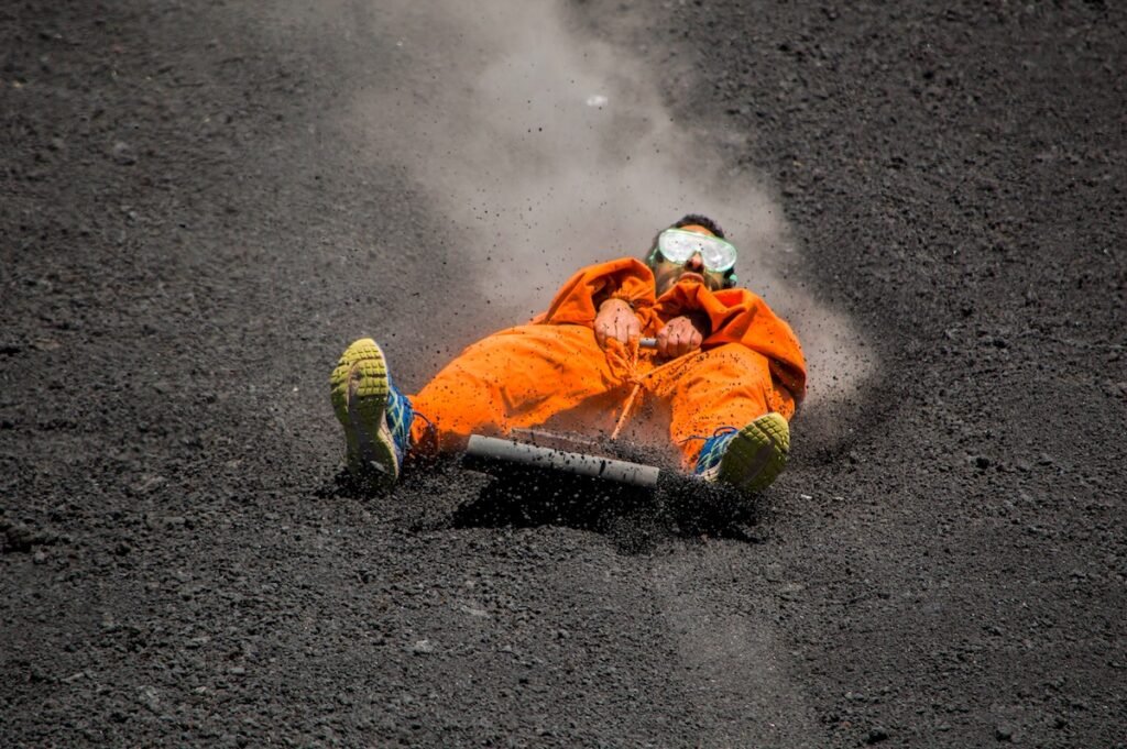 A guy is doing volcano boarding in the Cerro Negro of Nicaragua Break Boundaries: Epic Experiences for the Ultimate Risk-Taker thrill-seeking