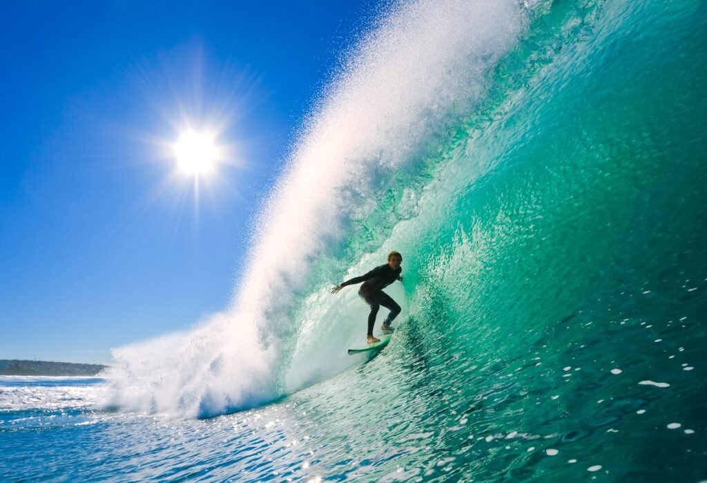 Surfer on perfect wave in the barrel Break Boundaries: Epic Experiences for the Ultimate Risk-Taker thrill-seeking