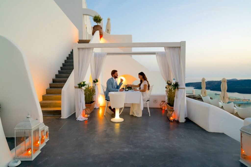 couple having candlelight dinner on romantic terrace with seaview honeymoon, vacation