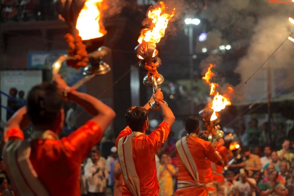 VARANASI, INDIA- Hindu priests perform the Ganga Aarti ritual in Dassaswamedh Ghat on the banks of the river Ganges in Varanasi, India. coolest vacation spots