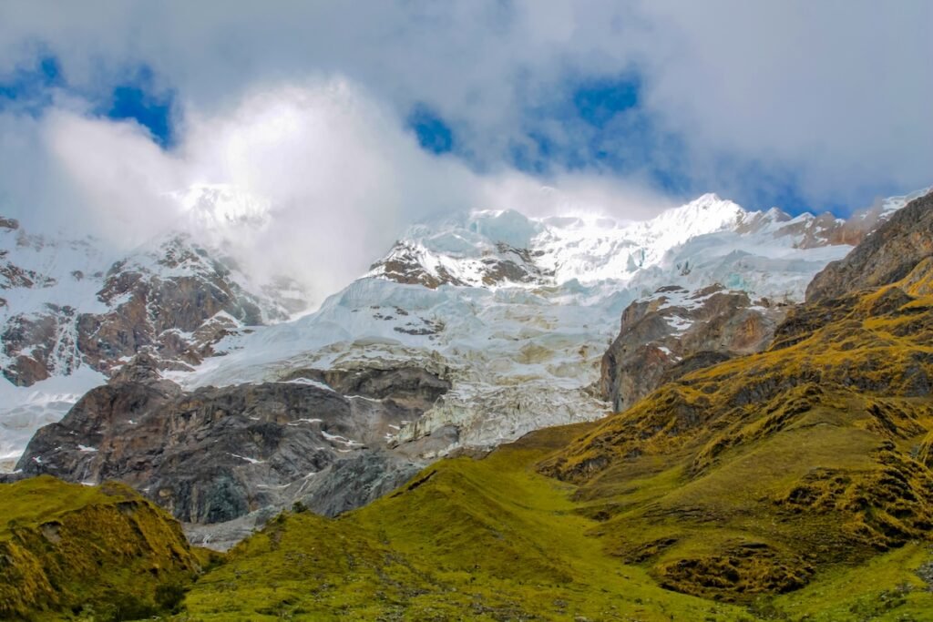 Salkantay mountain and lake on a trek to Machu Picchu in the Andes, Peru. Peruvian trekking and hiking in the Andes mountain, Salkantay summit glacier snow and ice above green valley, coolest vacation spots