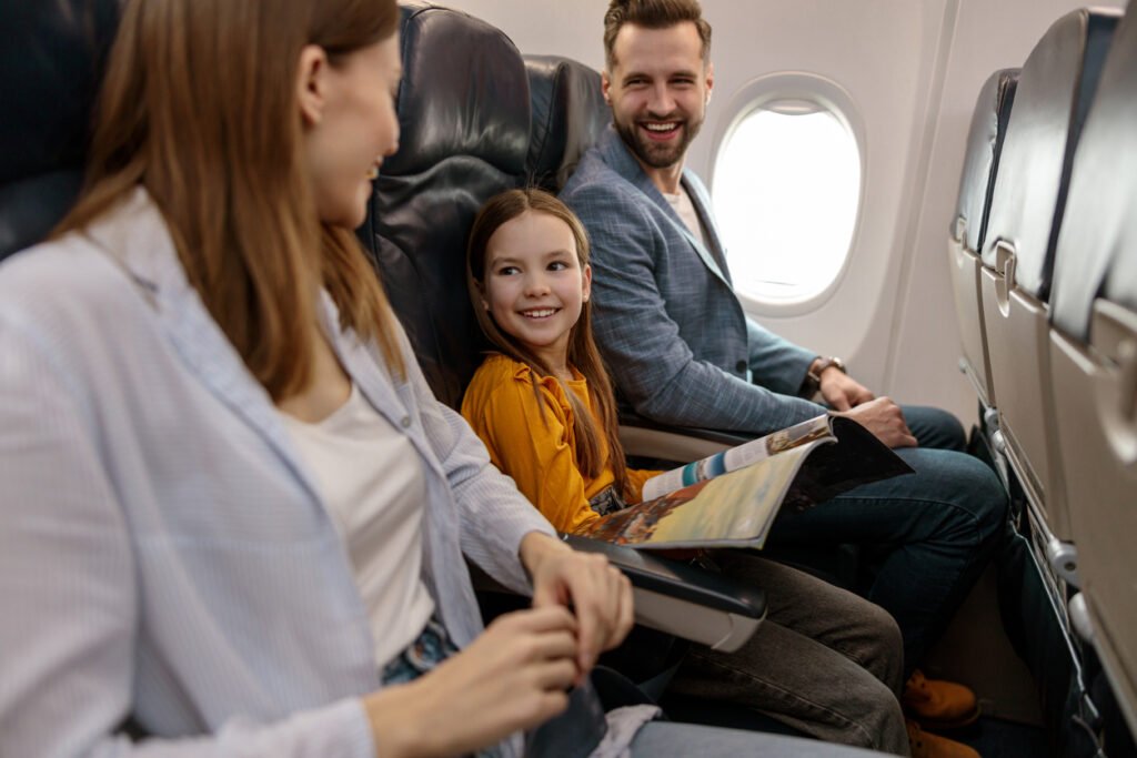 family on plane long flight with kids europe.jpg cheap family flights to Europe
