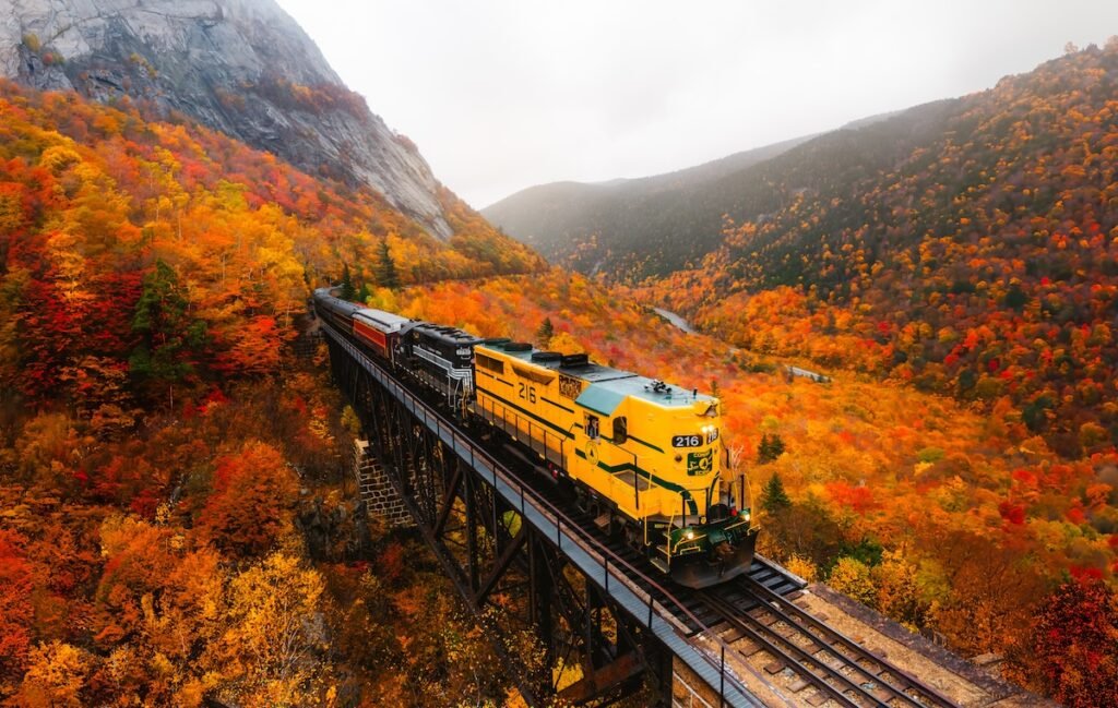 Conway Scenic Railroad North Conway, New Hampshire - Famous Conway Train Touring New England Scenic Ride on Tracks Fall Foliage. Colorful Forest Trees fall foliage train rides