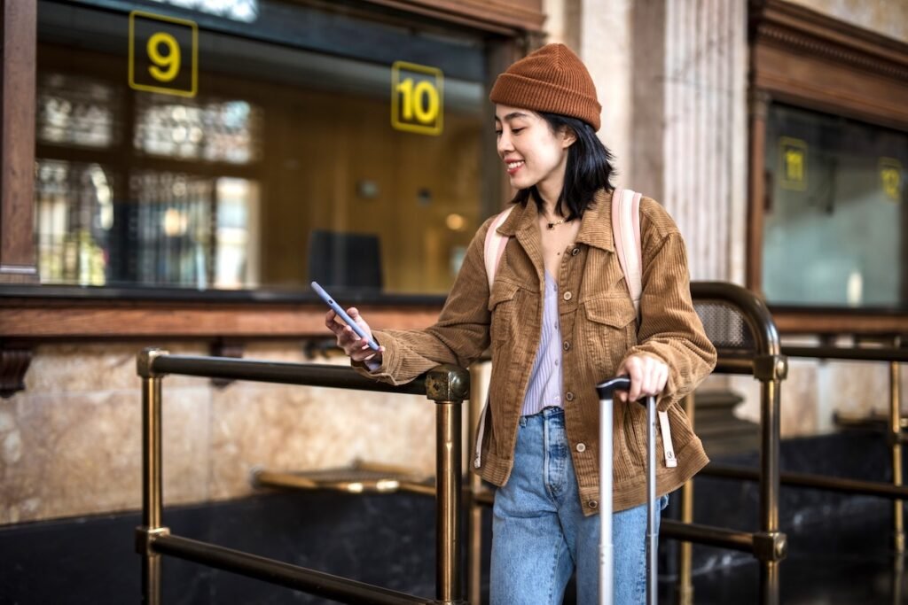 A young beautiful Chinese woman is waiting at the airport counter to check in her plane ticket. best apps