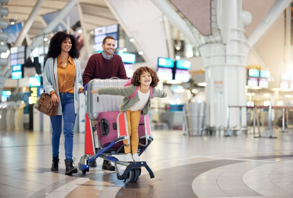 Happy family with young child at airport &mdash; affordable family vacations made simple