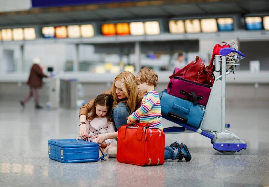 mom kids overpacked luggage airport floor family vacation mistakes to avoid